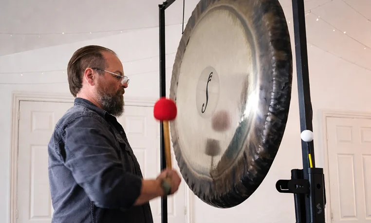 James playing a large gong