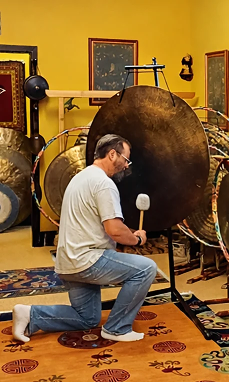 James playing a gong
